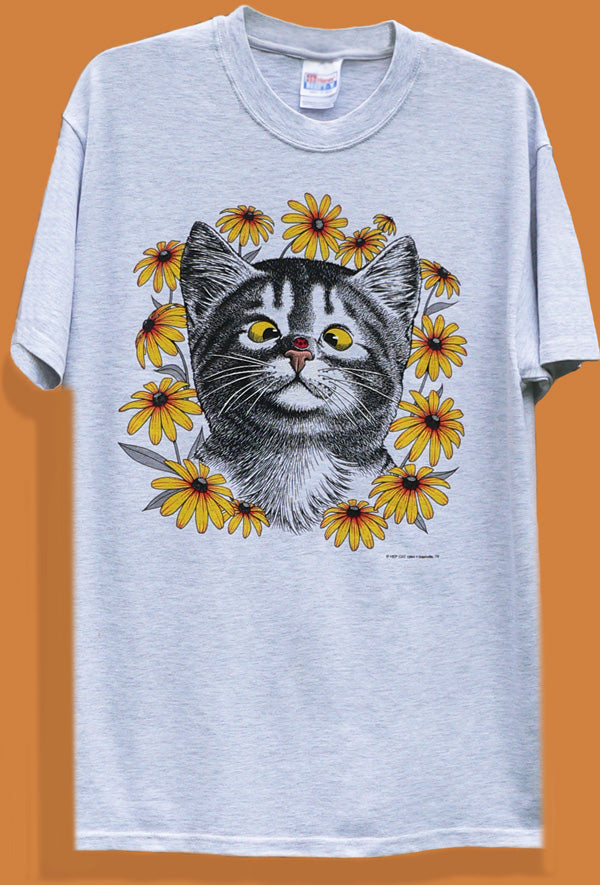 A fray t-shirt with a graphic print of a cat's face surrounded by flowers.