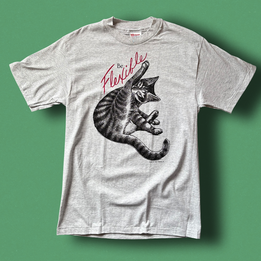 A gray t-shirt with a graphic of a cat and the text 'Flexible' printed above it. Hep Cat