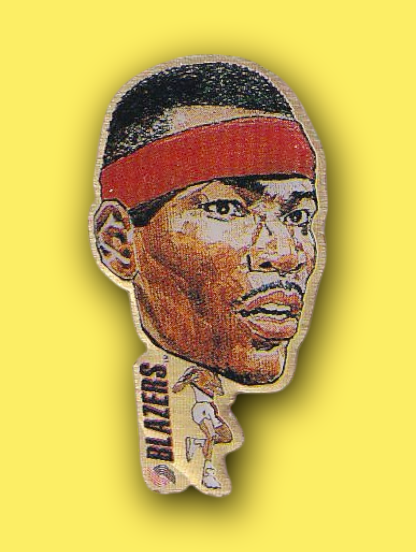 An enamel pin featuring a portrait of Cliff Robinson