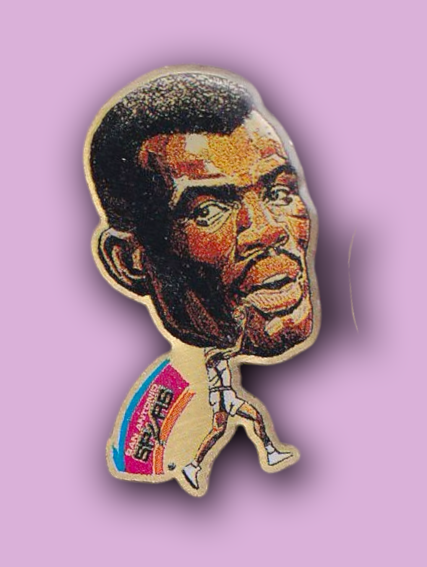 An enamel pin featuring a portrait of David Robinson