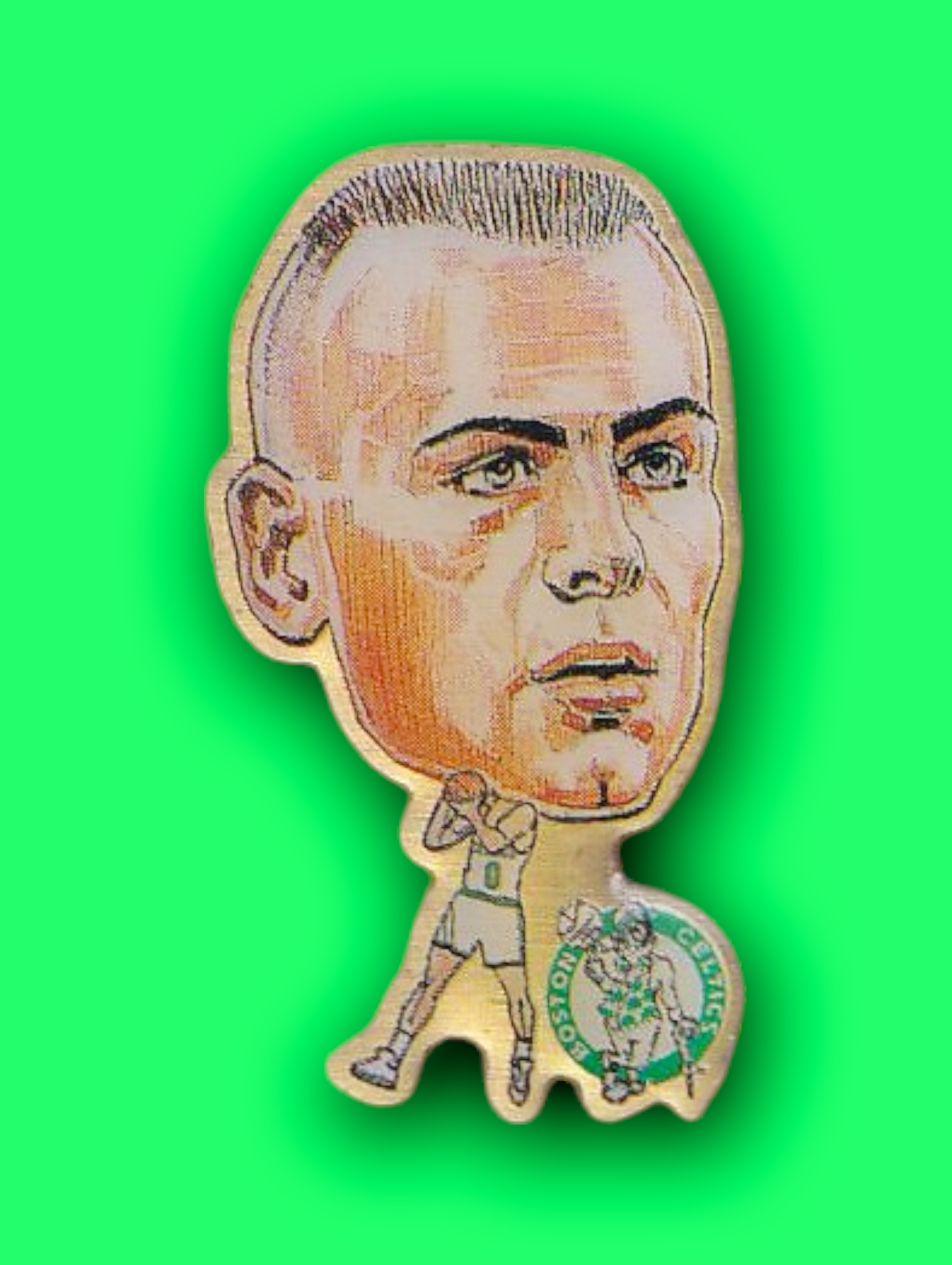 An enamel pin featuring a portrait of Eric Montross