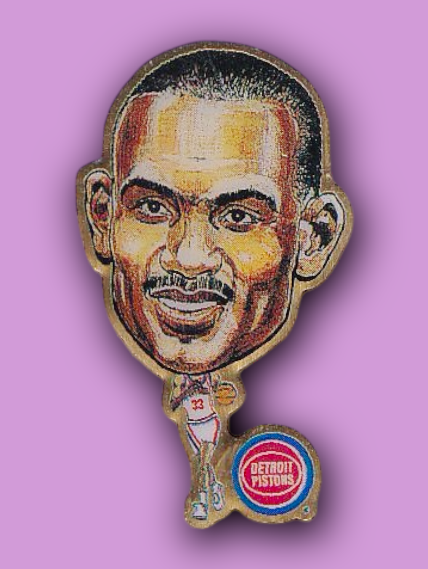 An enamel pin featuring a portrait of Grant Hill