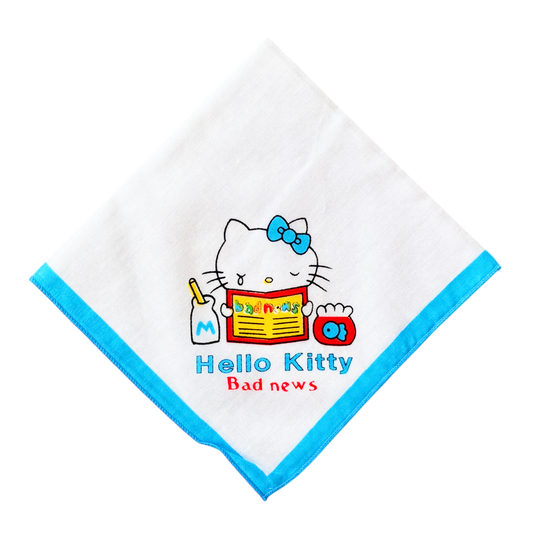 A white handkerchief with a blue border featuring an illustration of Hello Kitty holding a bad news paper.