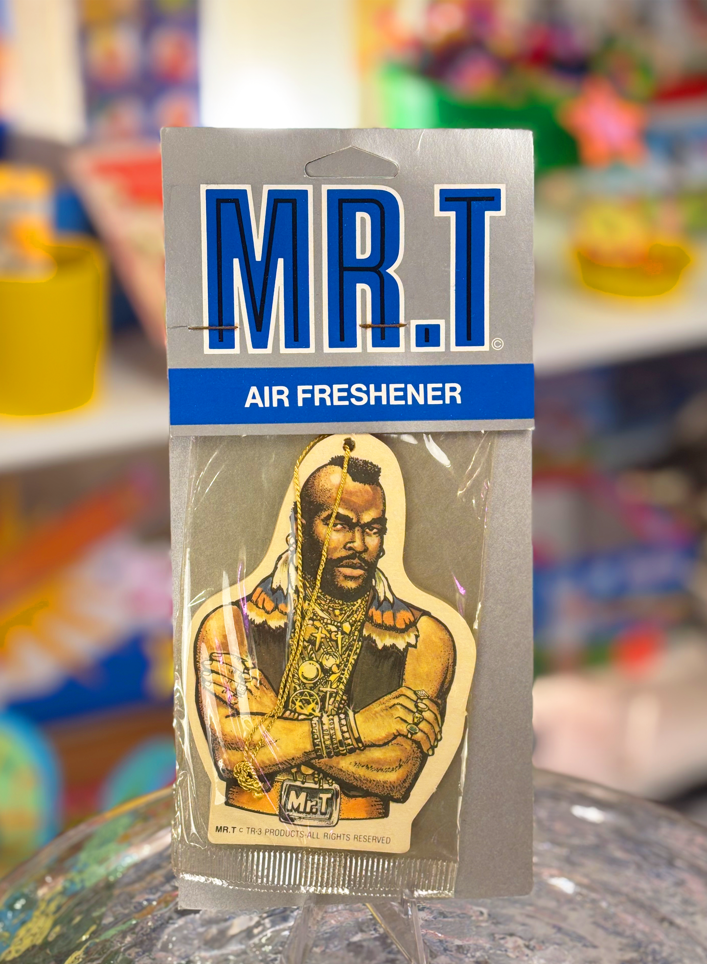 Mr. T air freshener in original packaging, featuring an illustration of the character on a blue and white background.