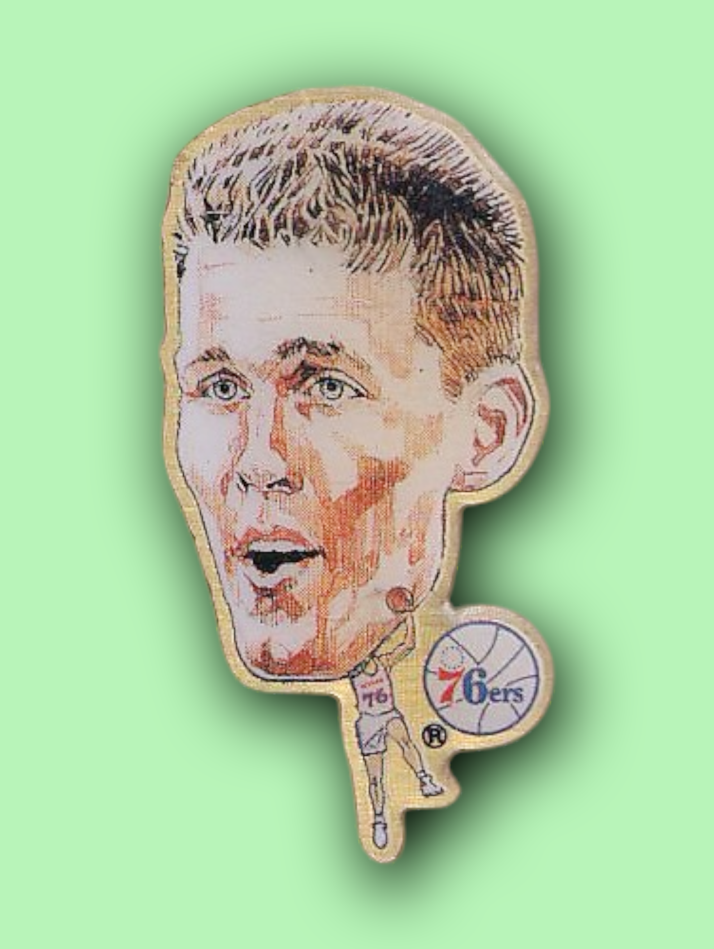 An enamel pin featuring a portrait of Shawn Bradley
