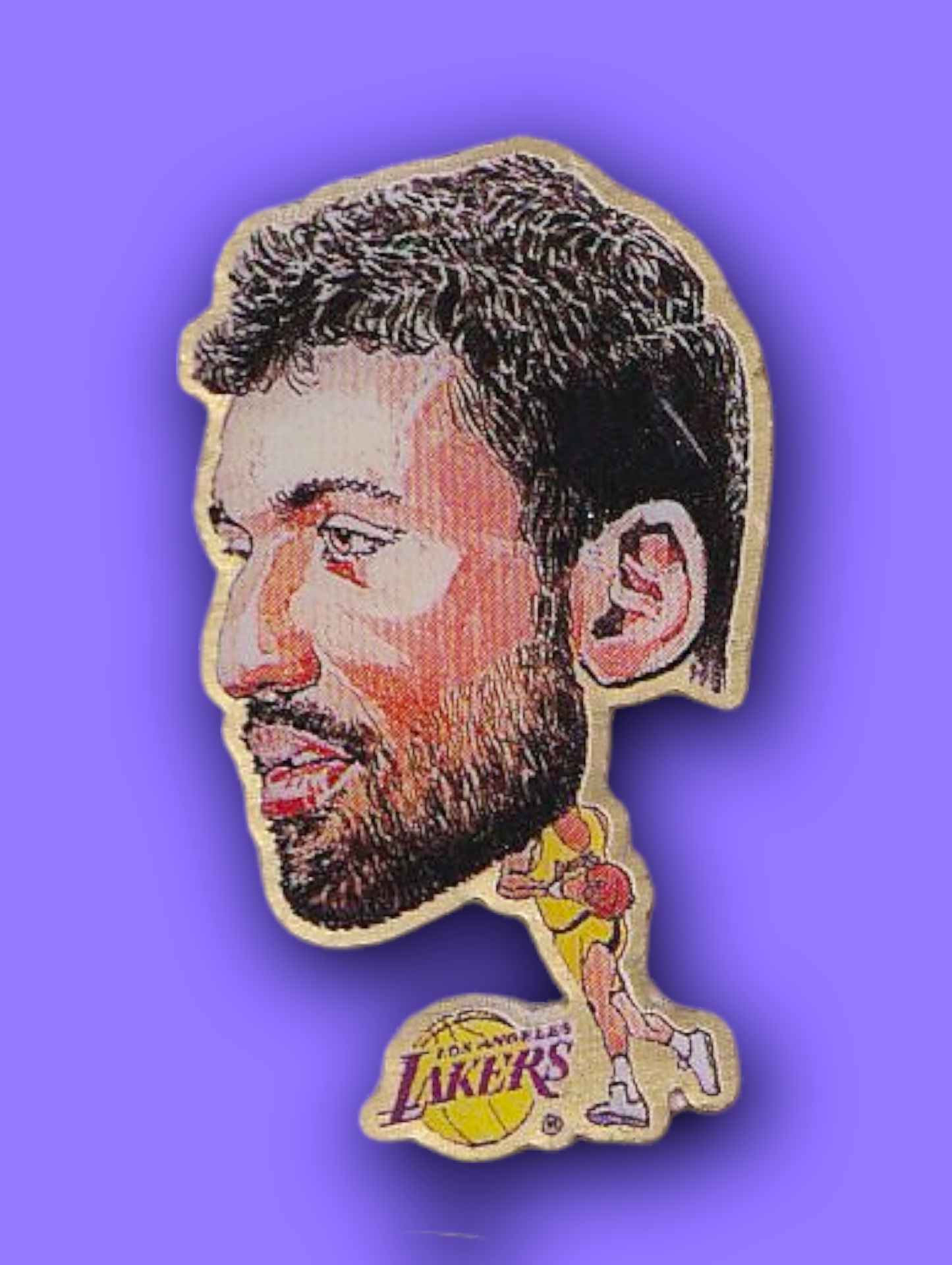 An enamel pin featuring a portrait of Vlade Divac