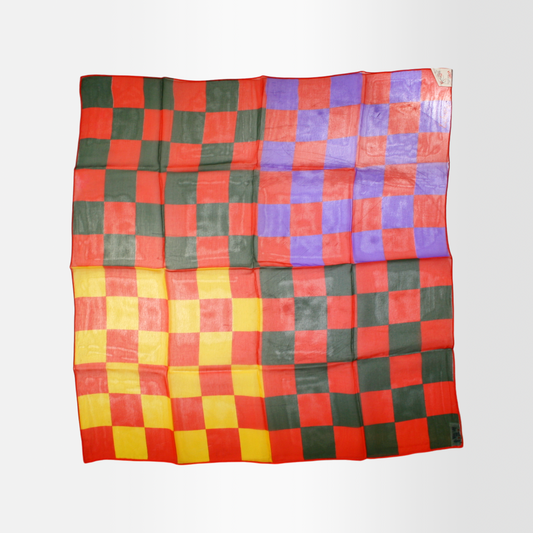 A multicolored sheer scarf with a checkered pattern laid out flat.