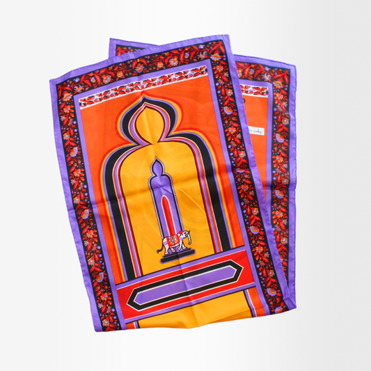 A silk scarf with a bold, colorful 'Elephant' print design, featuring orange, purple, and yellow tones with a geometric patterned border.