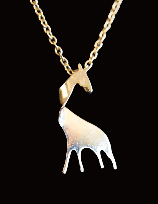 A gold-colored pendant in the shape of a giraffe, suspended from a chain.