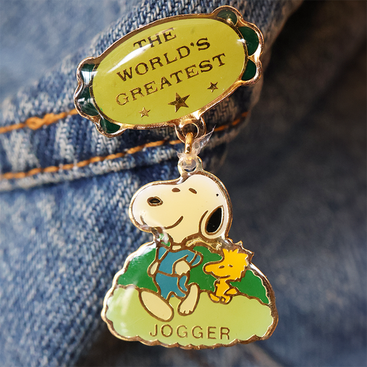 Pin with Snoopy and Woodstock on a denim background