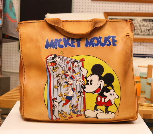 A brown leather hand-tooled and painted messenger bag featuring a vibrant graphic of Mickey Mouse and friends.
