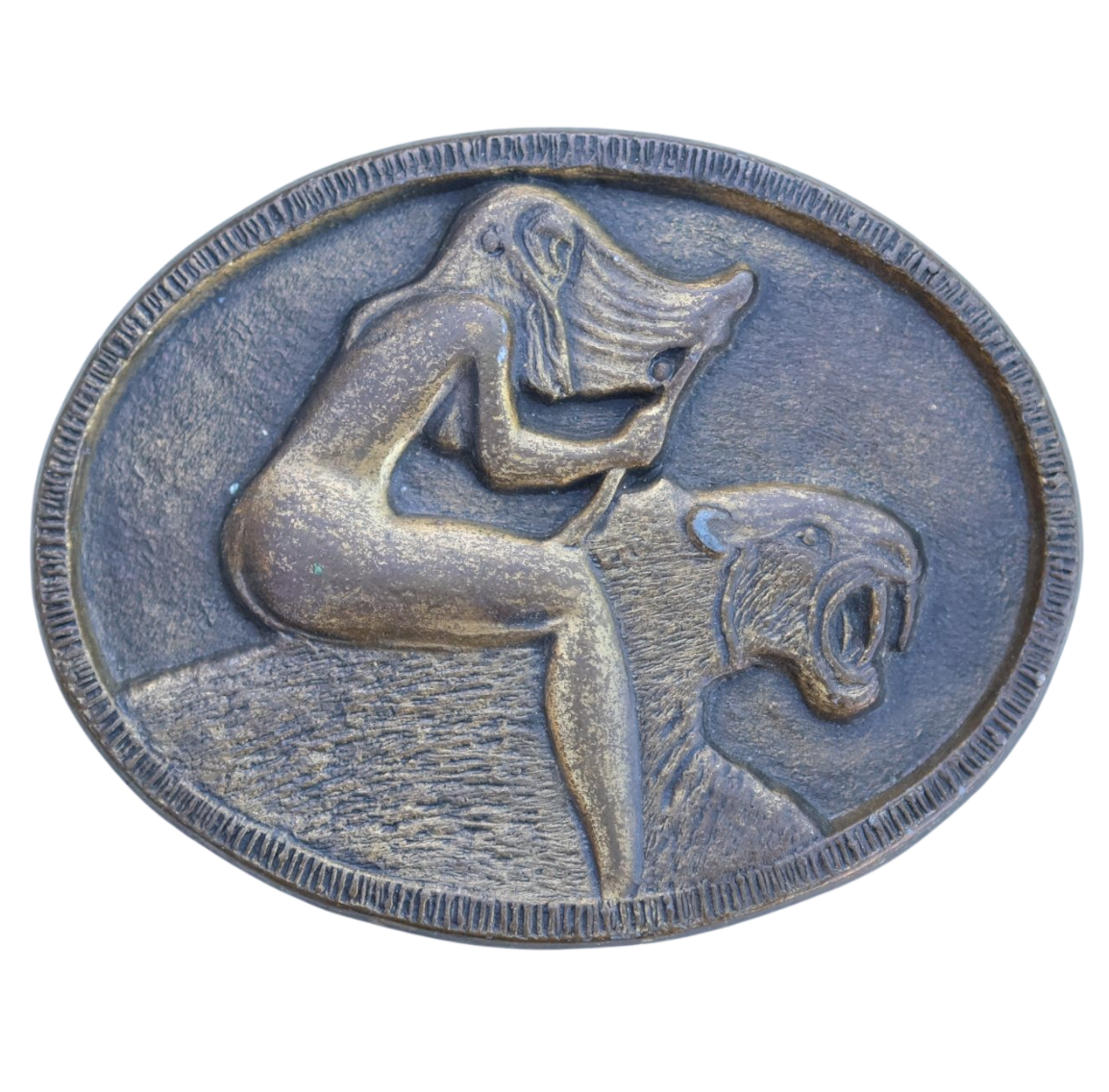 vintage belt buckle of a woman riding a sabertooth tiger