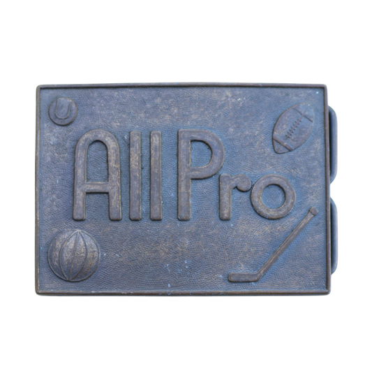 vintage brass belt buckle reading "all pro" with hockey, basket, baseball, and football symbols