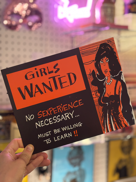 A hand holding a vintage-style novelty print with the title 'Girls Wanted' and the text 'No Sexperience Necessary.