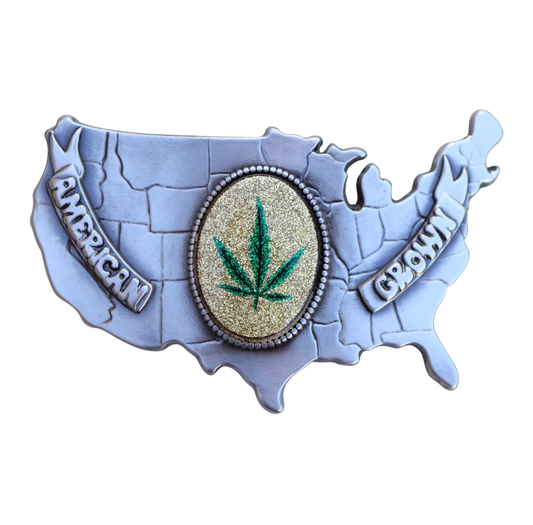 vintage belt buckle of the usa with a marijuana leaf emblem in the middle reading 'american grown'