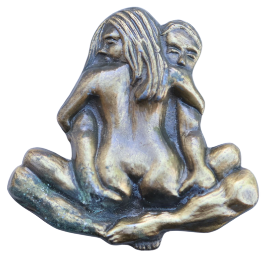 vintage belt buckle with a nude couple in a suggestive position