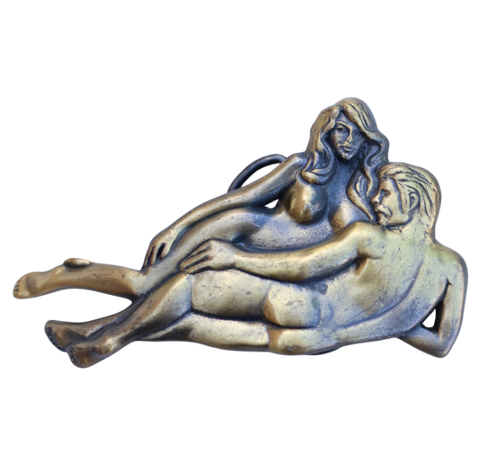 vintage belt buckle with laying nude couple