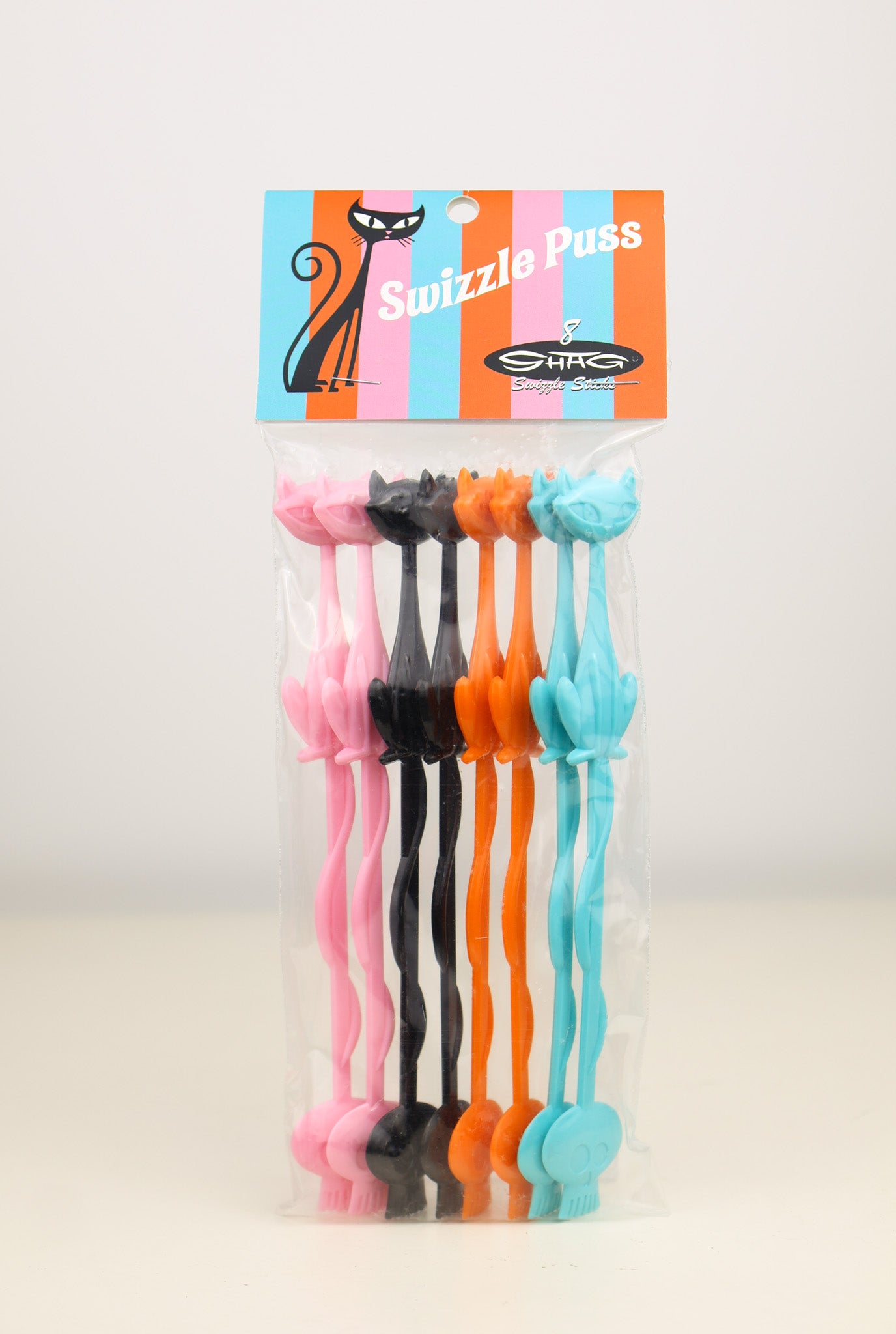 Set of colorful Shag, Josh Agle Cat swizzle sticks with a branded packaging on a light background