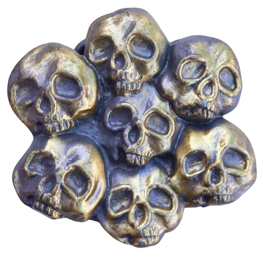 vintage belt buckle with multiple skull designs on a white background