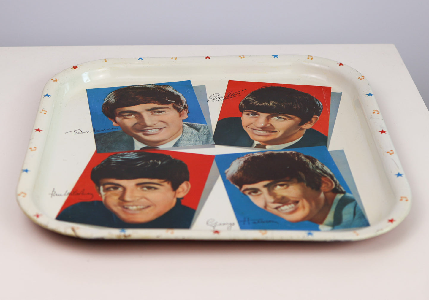 Vintage 1964 Tray with images of the Beatles on a white background