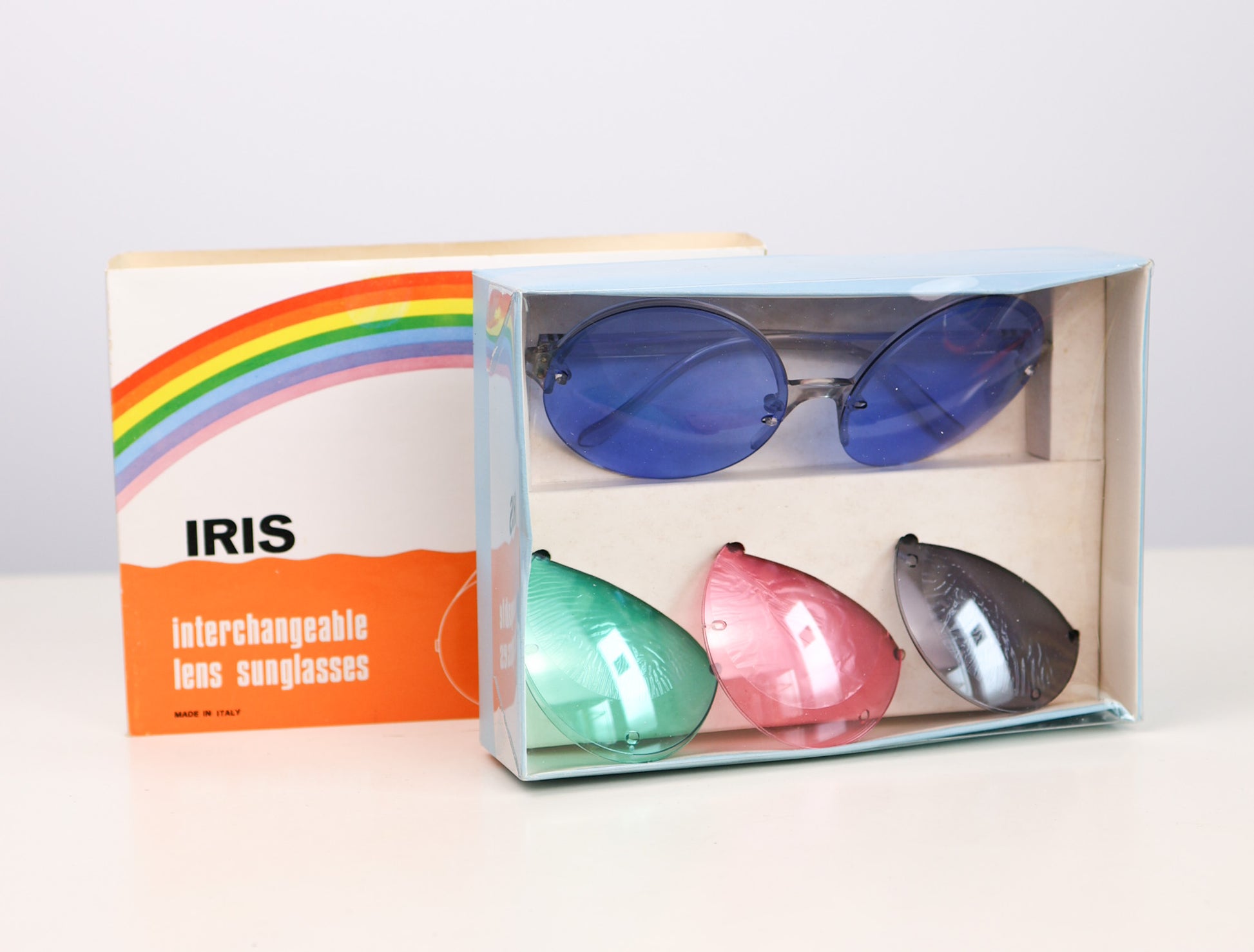 vintage deadstock Italian Colorful sunglasses with interchangeable lenses in a box, branded 'IRIS'.