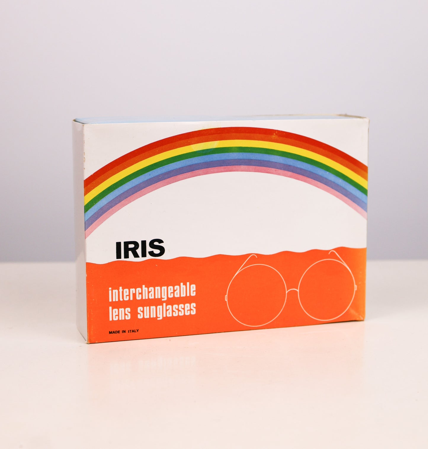 Box of Iris interchangeable lens sunglasses with a rainbow design on a white background