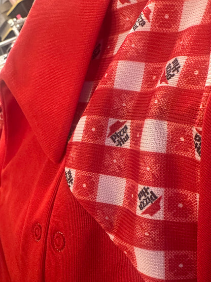 Close up of Vintage Pizza Hut Red Uniform shirt top. New Old Stock Deadstock with Pizza Hut signature table cloth print on yoke
