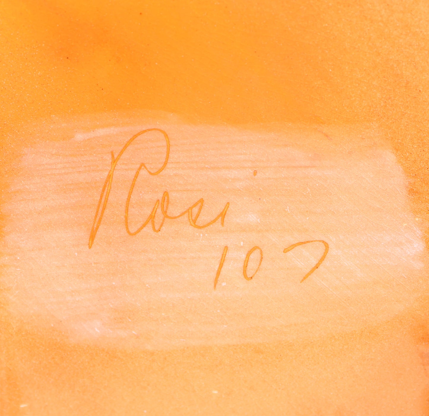Close-up of back of a mid century pottery plate signed 'Rosi 107' 
