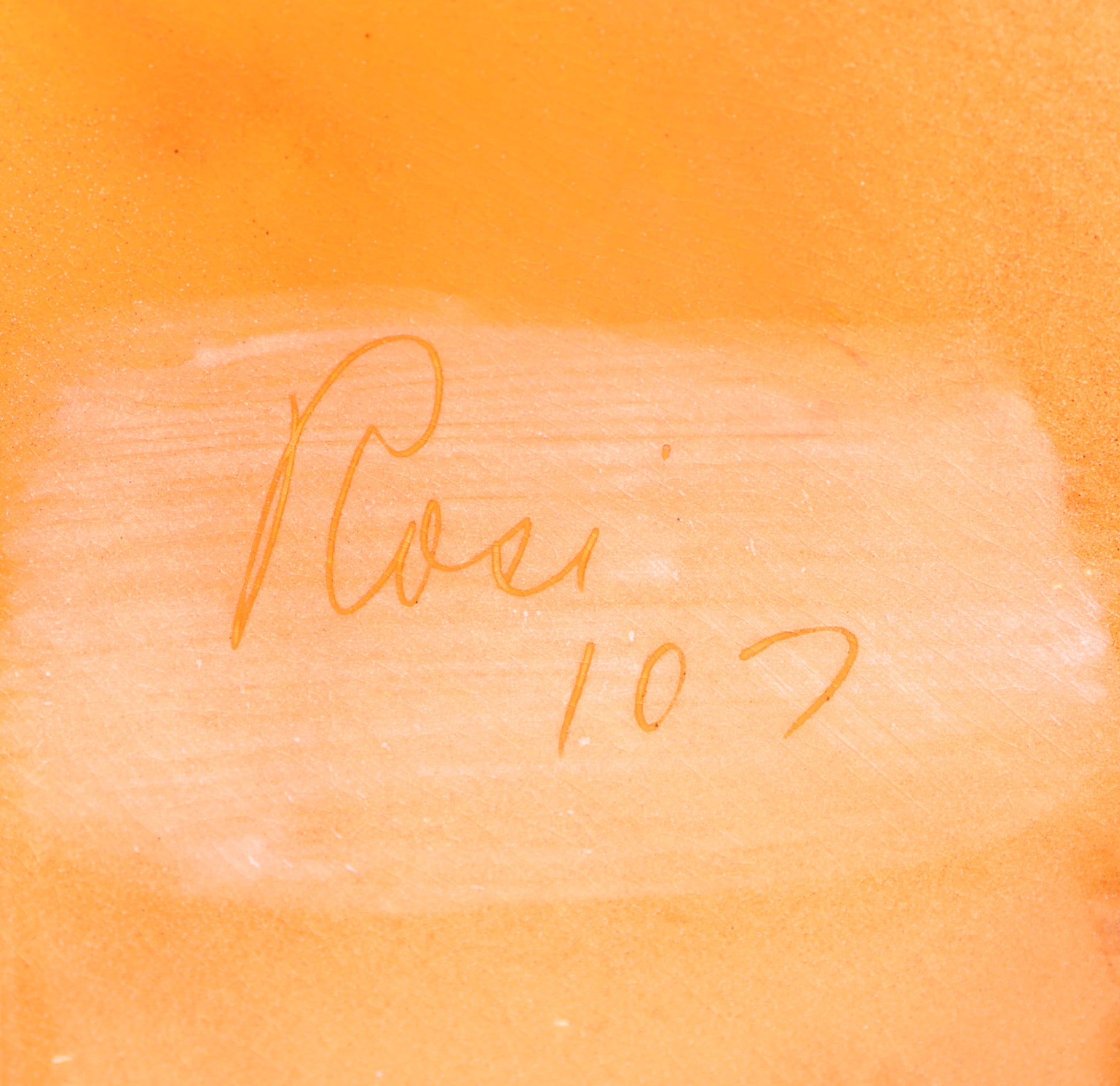 Close-up of back of a mid century pottery plate signed 'Rosi 107' 