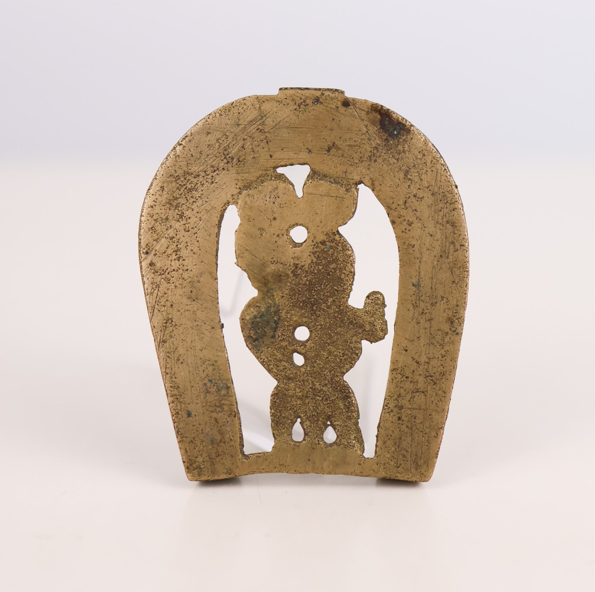 Bronze horseshoe with a cut-out figure on a white background