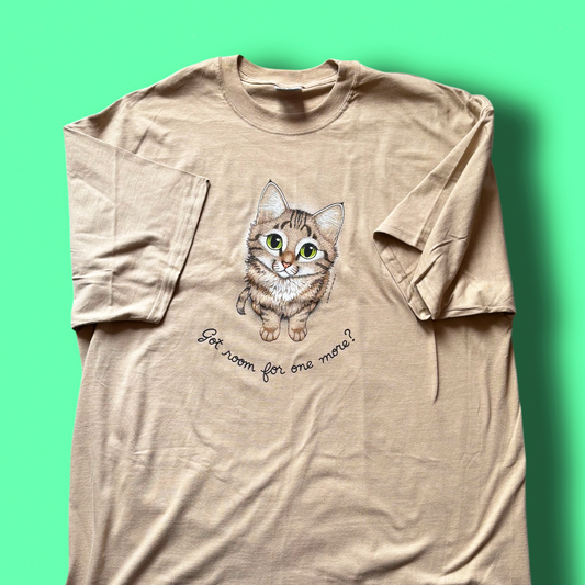A beige t-shirt with a graphic of a cat and the text 'Got room for one more?' printed on the front. Vintage Hep Cat Tee
