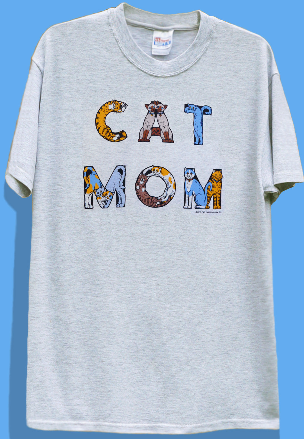 Greycrew neck t-shirt with the text 'CAT MOM' printed in bold letters, featuring a graphic of a cat in each letter.