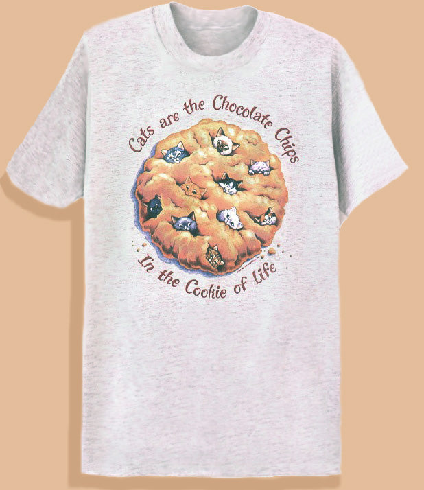 White crew neck t-shirt with a graphic of a chocolate chip cookie and text 'Cats are the Chocolate Chips to the Cookie of Life'.