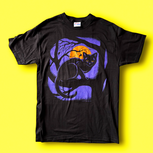 Black crew neck t-shirt with a graphic of a black cat sitting beside a purple moon and tree branches, displayed against a yellow background. Vintage Hep Cat Tee