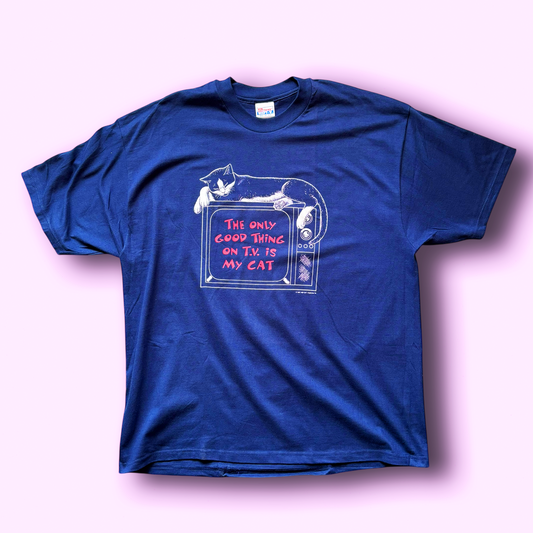 A vintage blue t-shirt with a graphic print of a cat asleep on a television and the text 'The only good thing on TV is my cat'.