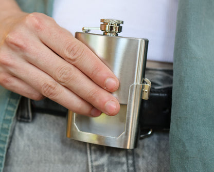 Vintage belt buckle flask being holstered. Being modeled for fashion and function.