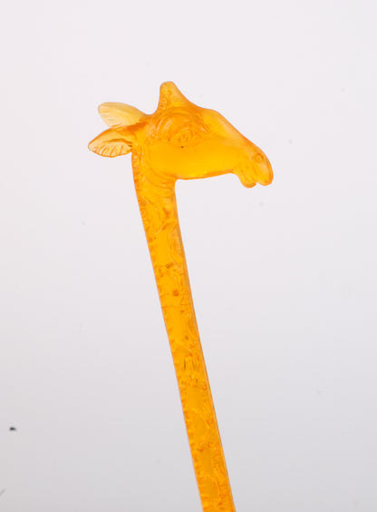 Vintage 1960s Giraffe Orange plastic stirrer with a unique design on a white background