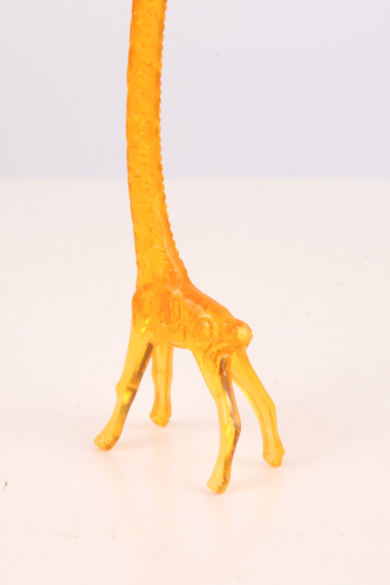 Yellow giraffe stir stick on a white background
