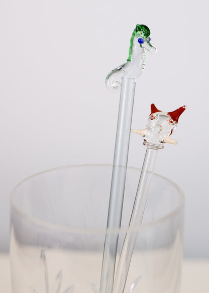 Decorative glass swizzle sticks with a seahorse design on a white background