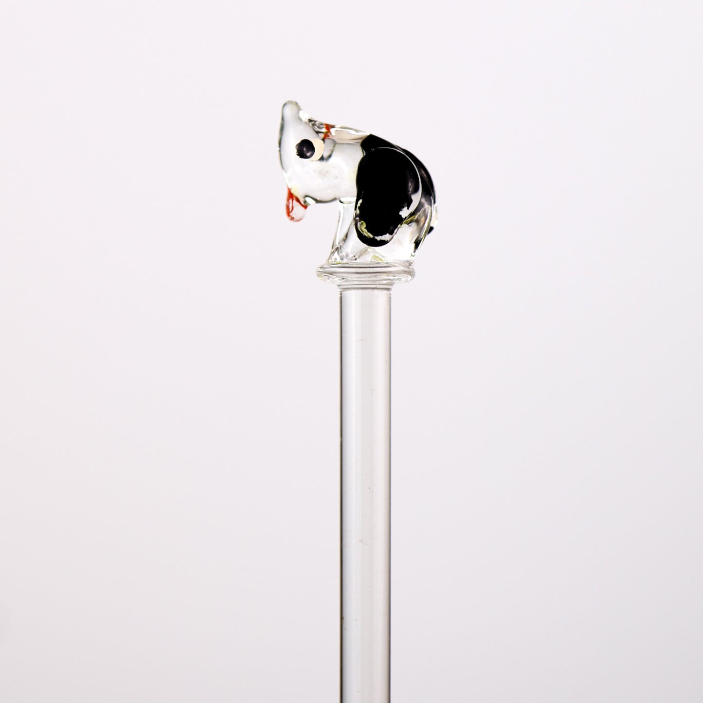 glass swizzle stick with animal top on a white background