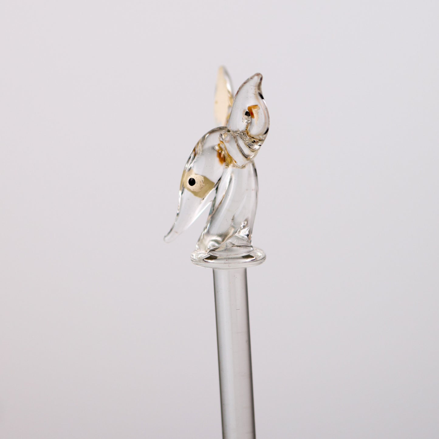 Glass swizzle stick of a doe deer on a white background