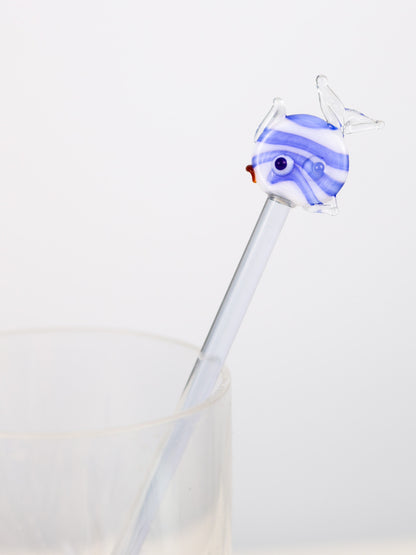 hand blown Glass swizzle stick  with a blue and white fish-shaped top on a light gray background
