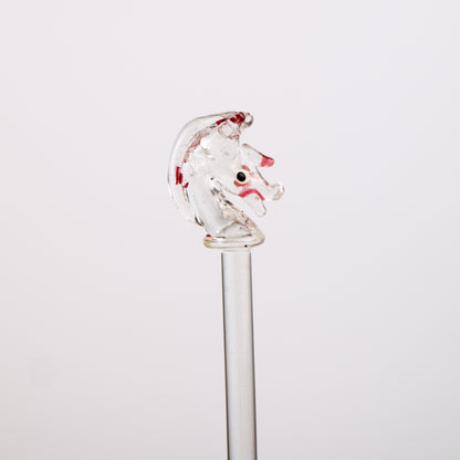 Glassswizzle stick with a horse head design on a white background