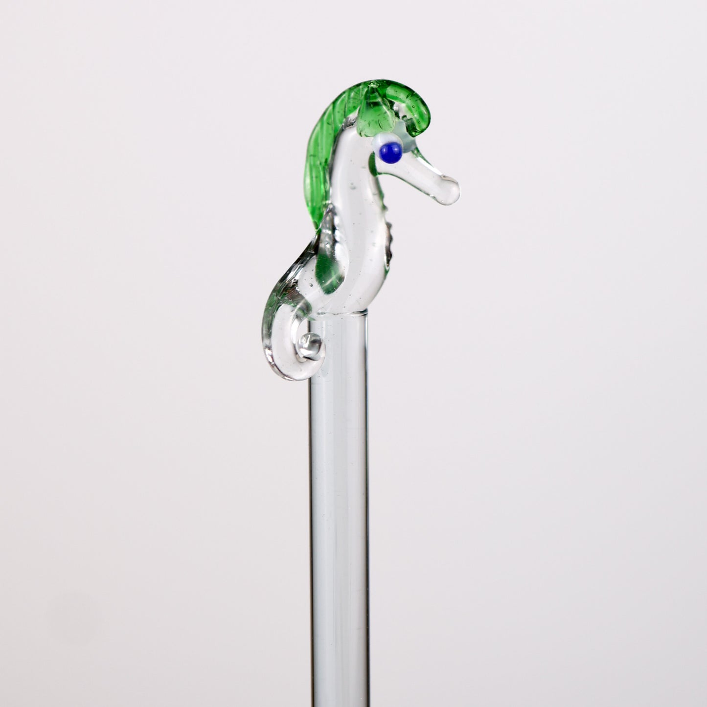 Glass seahorse stirrer on a white background