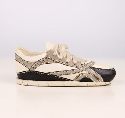 Vintage wood Sneaker sculpture with black and gray accents on a light background signed "Walker"