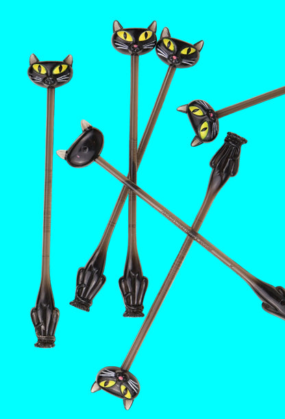 Black cat-shaped stir sticks on a white background Vintage y2k Accoutrements.
