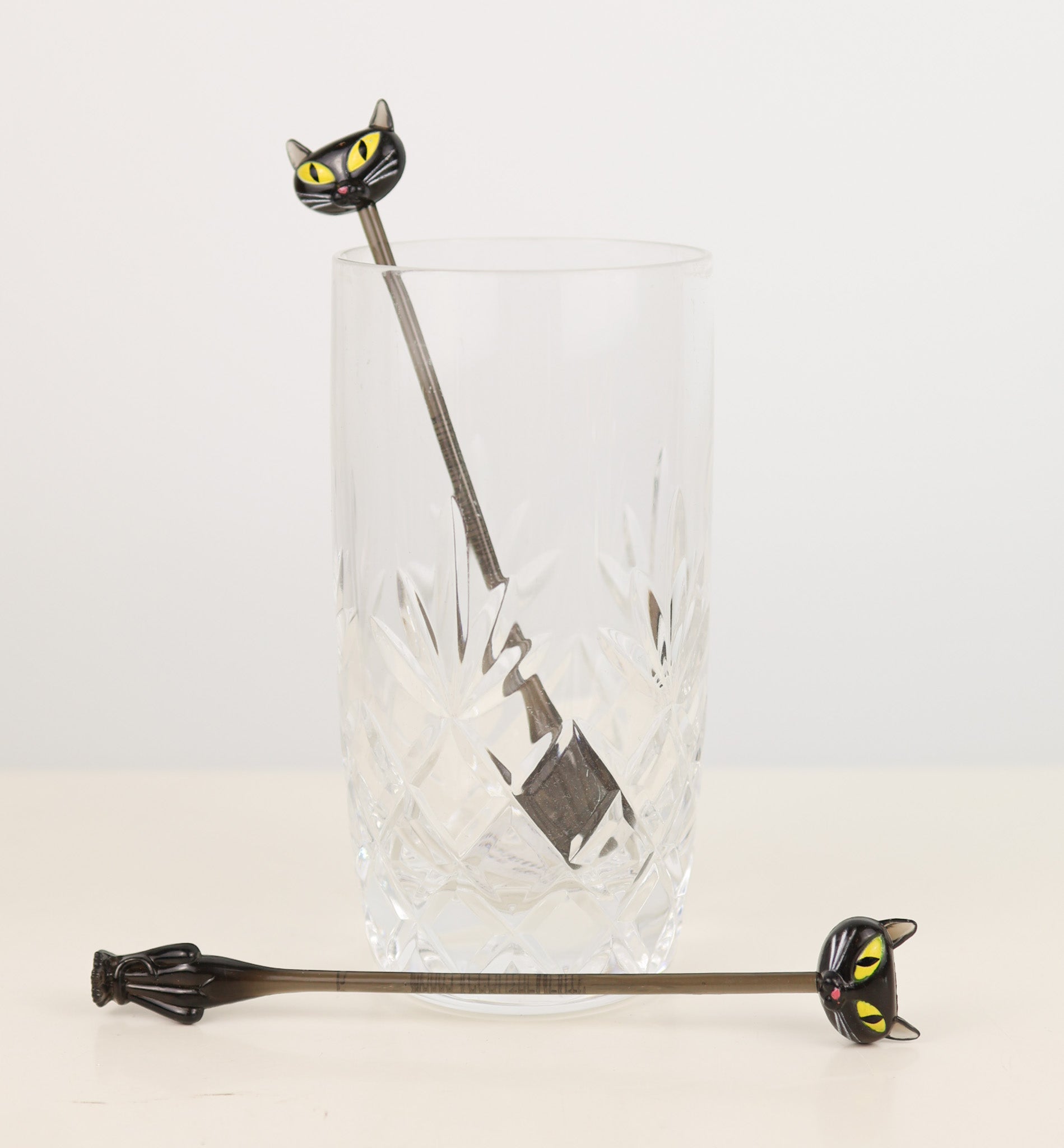 Cat-shaped stirrer with a glass on a white background Vintage y2k Accoutrements 